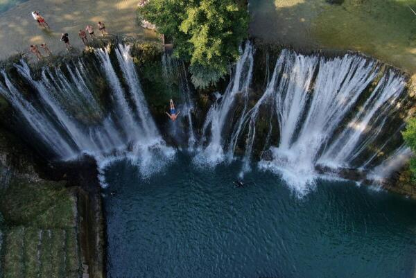 A drone view shows competitors taking part in the annual international waterfall jumping competition held in the old town of Jajce, Bosnia and Herzegovina.