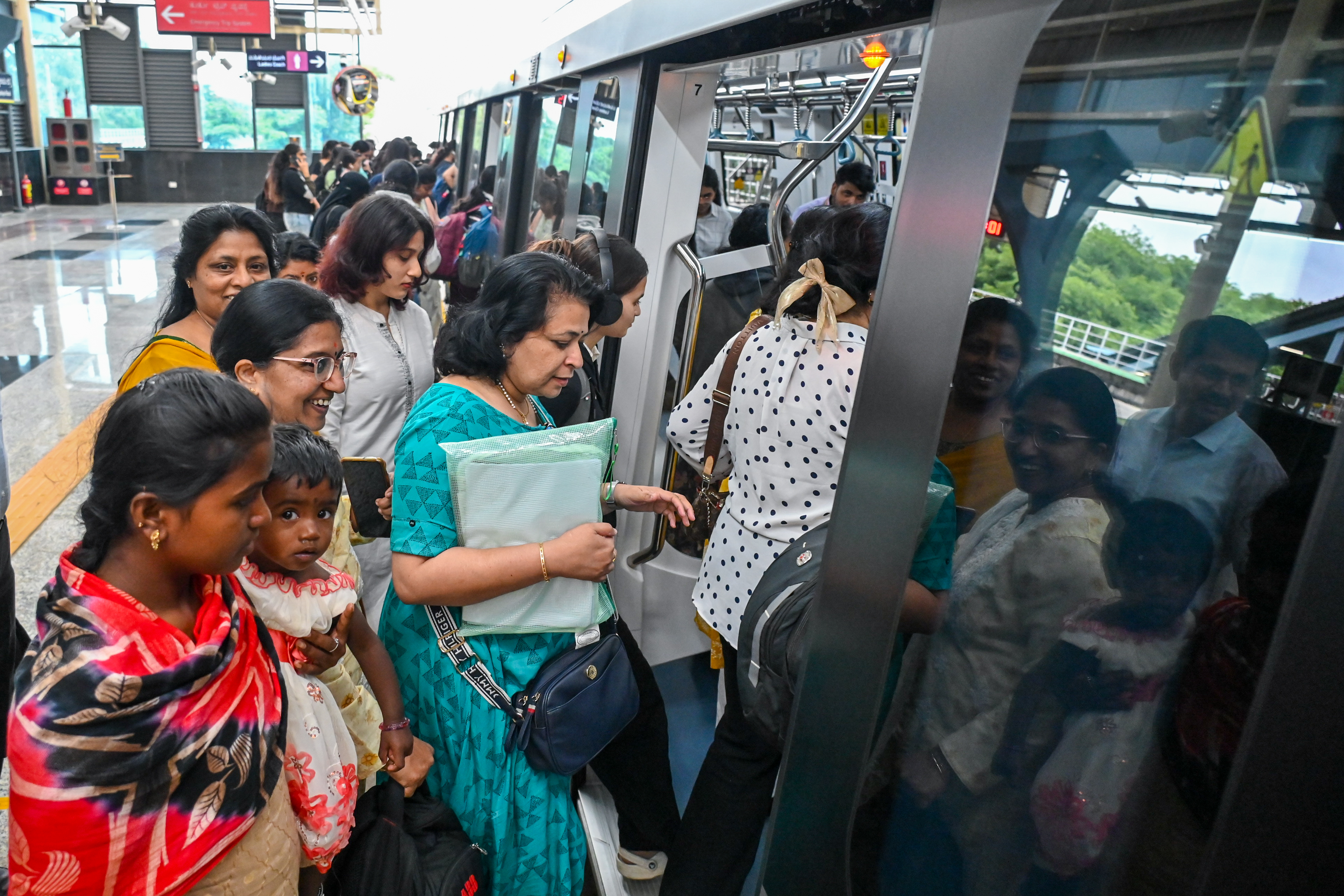 Metro commuters on the first day of commercial service on Namma Metro