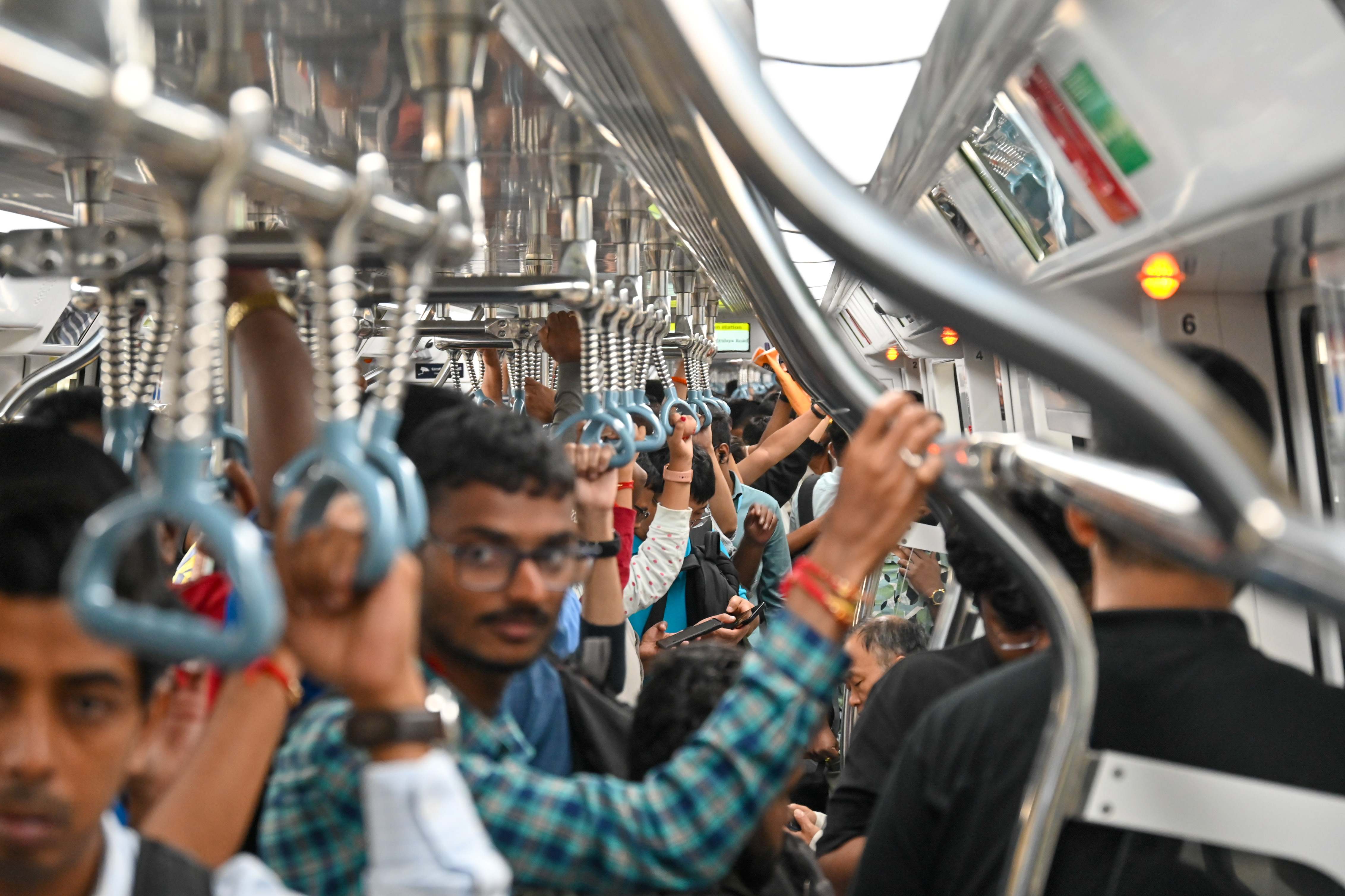 Metro commuters on the first day of commercial service of Namma Metro