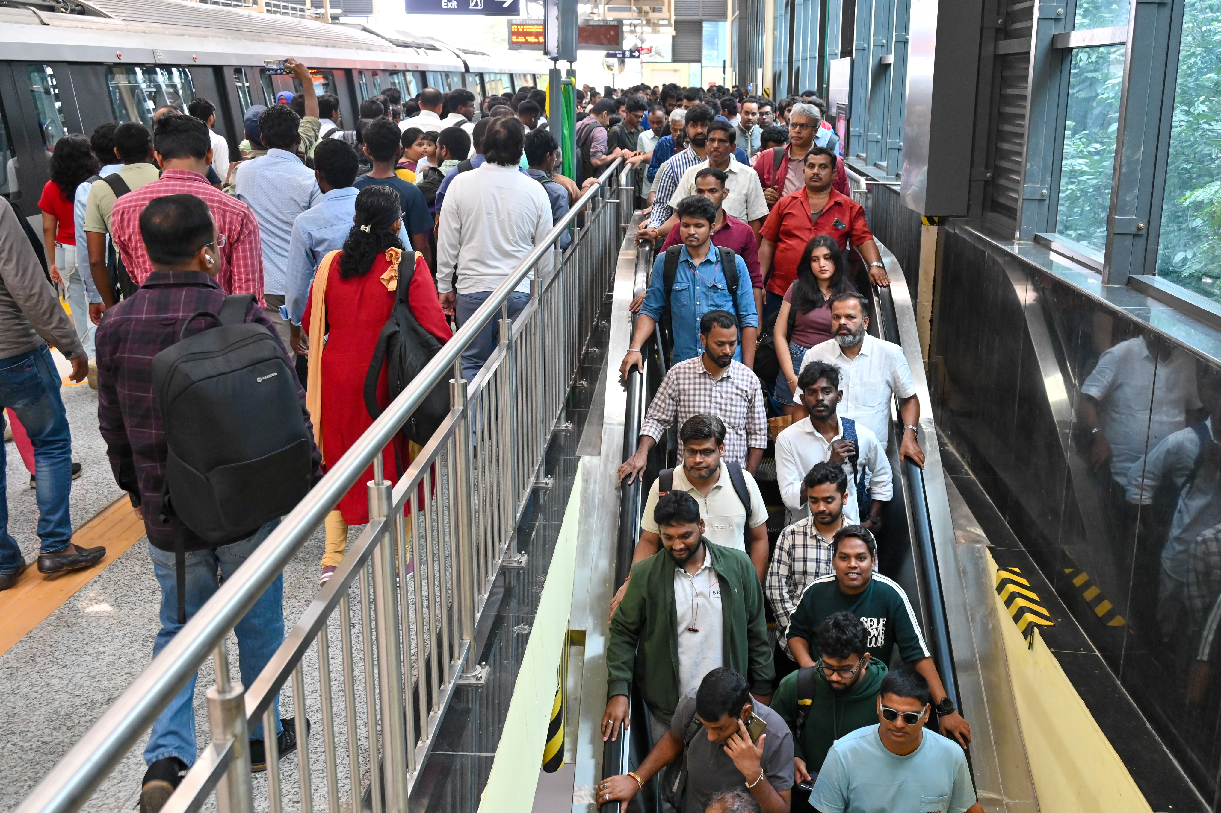 Metro commuters on the first day of commercial service on Namma Metro
