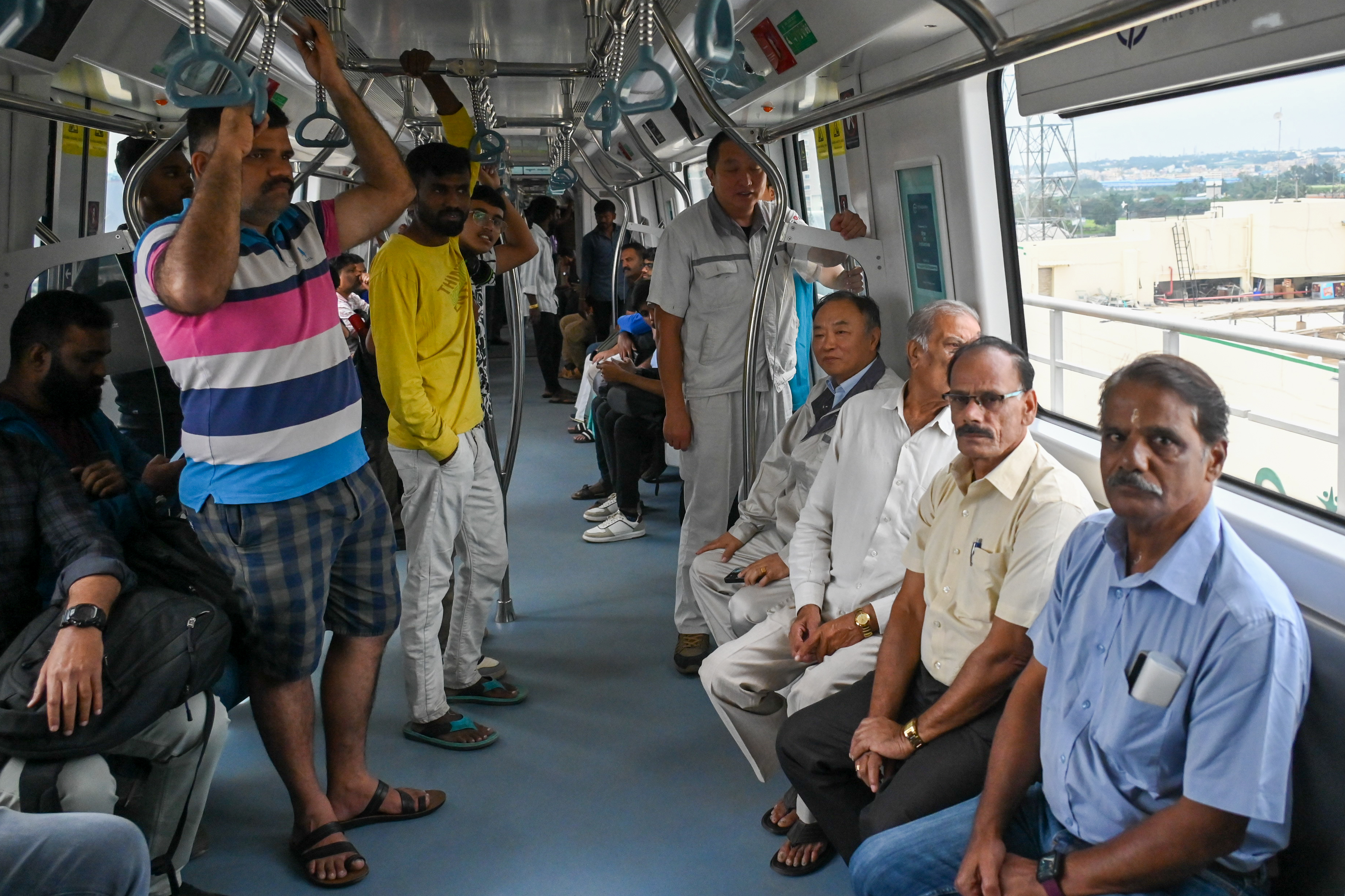 Metro commuters on the first day of commercial service of Namma Metro