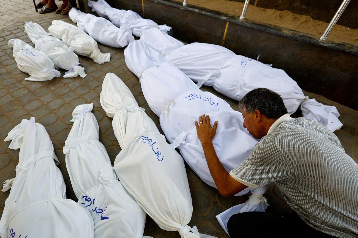 A mourner reacts during the funeral of Palestinians from Irheem family, who were killed in an overnight Israeli strike, according to medics, in Gaza City.
