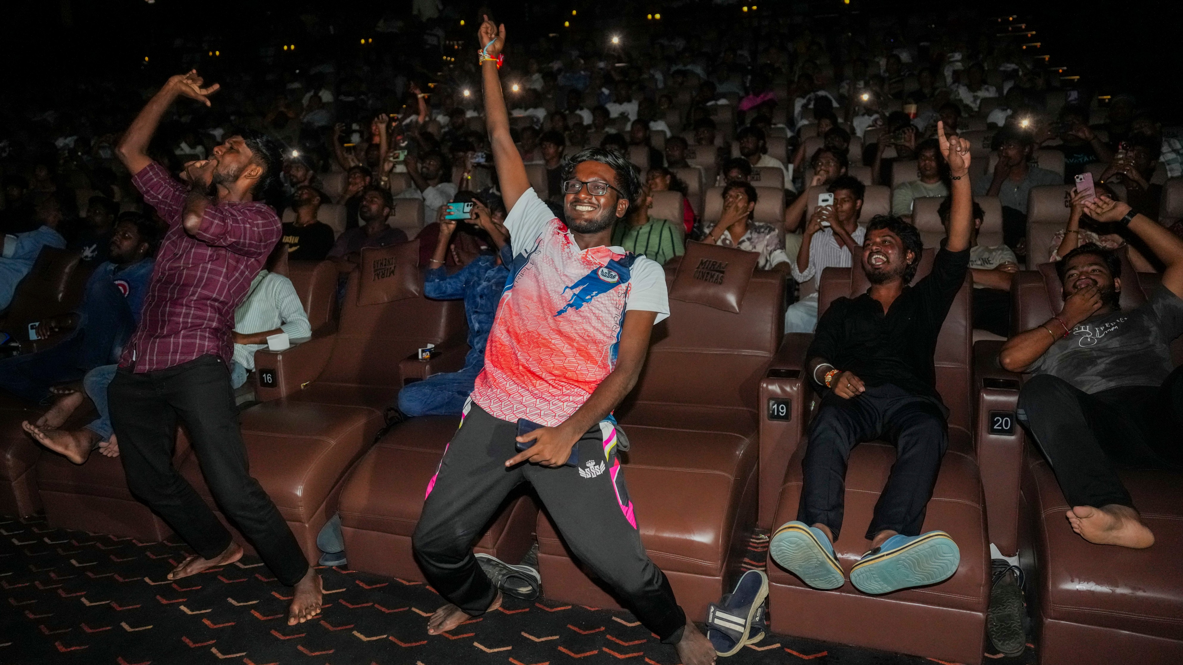 Fans of superstar Rajinikanth dance as they celebrate the release of Coolie in Mumbai.