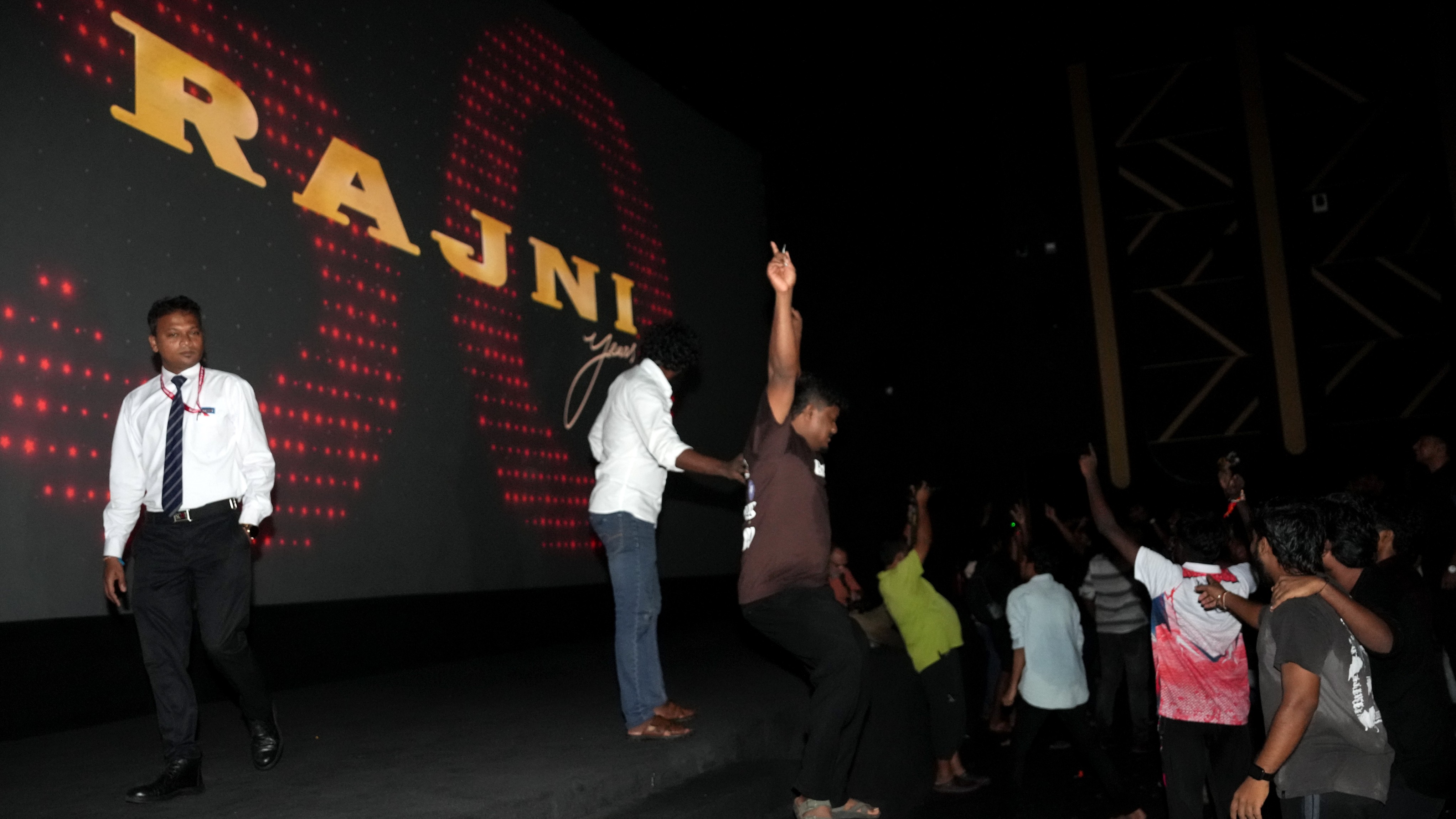 Fans of superstar Rajinikanth celebrate the first show of Coolie in Mumbai.