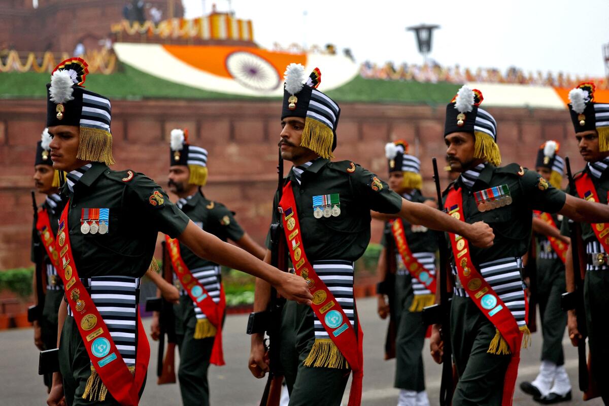 Soldiers take part in a march past during Independence Day celebrations at the Red Fort in Delhi