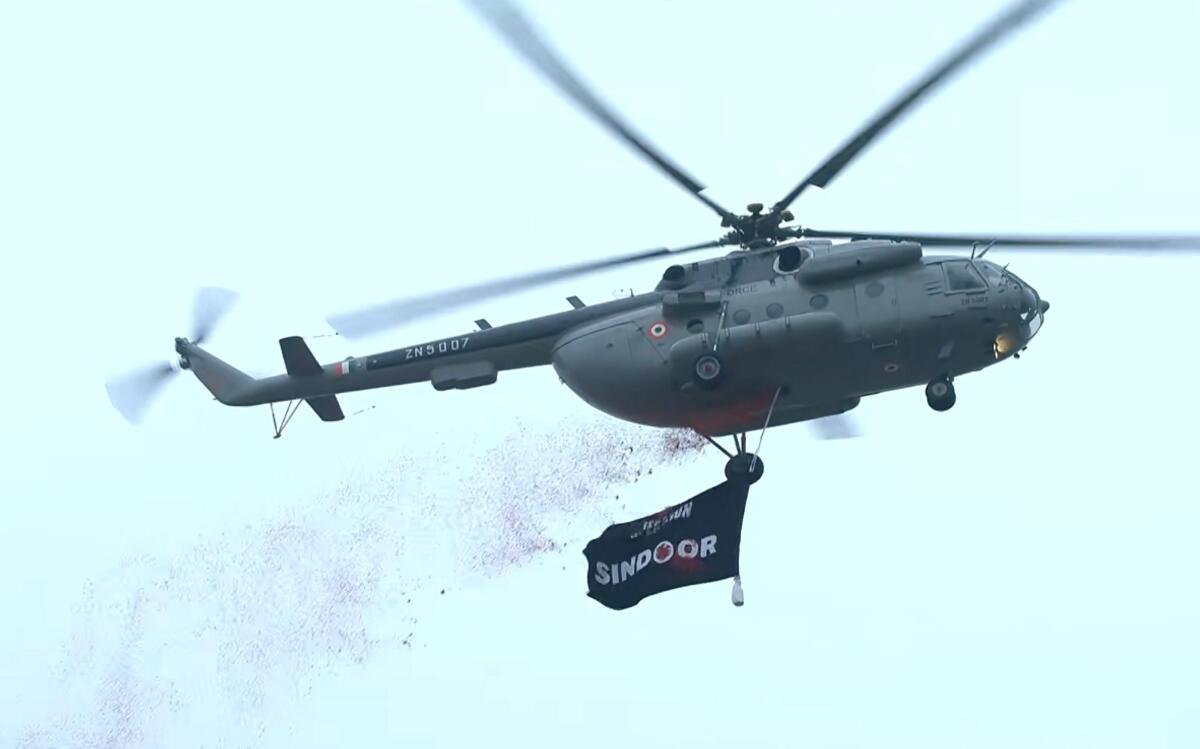 A military helicopter showers flower petals after Prime Minister Narendra Modi hoisted the national flag at the Red Fort 
