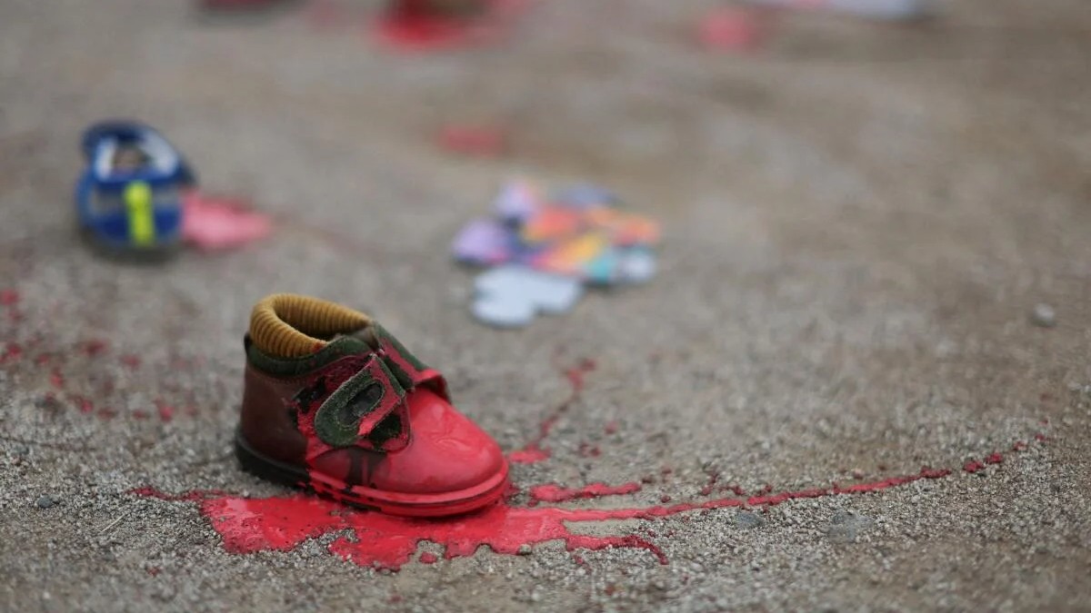A child's shoe painted red lies on the floor, near the Embassy of Egypt, during a protest in solidarity with Palestinians, in Santiago, Chile.