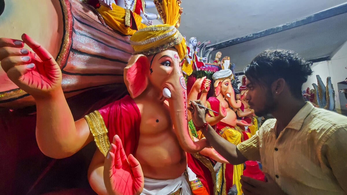 An artisan gives finishing touches to an idol of Lord Ganesh ahead of 'Ganesh Chaturthi' festival, in Agra.