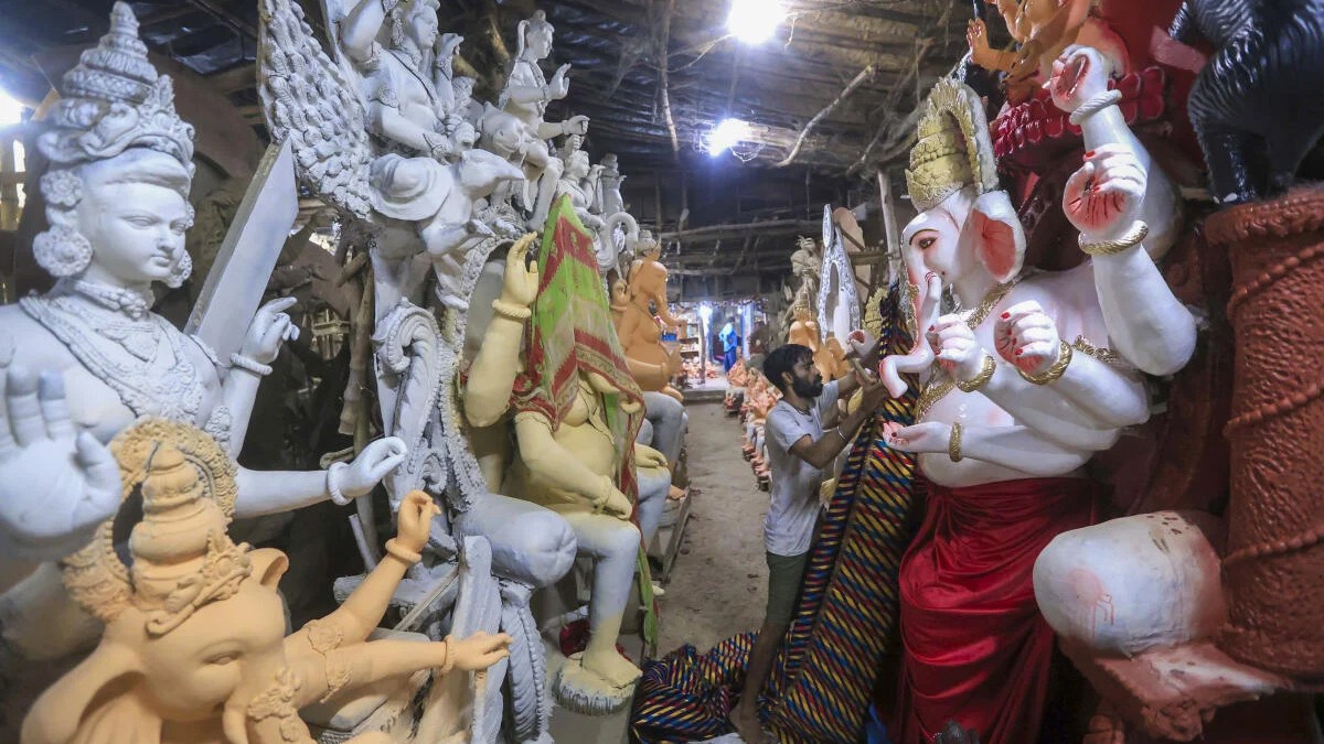 An artisan decorates an idol of Lord Ganesh ahead of 'Ganesh Chaturthi' festival, in Prayagraj.