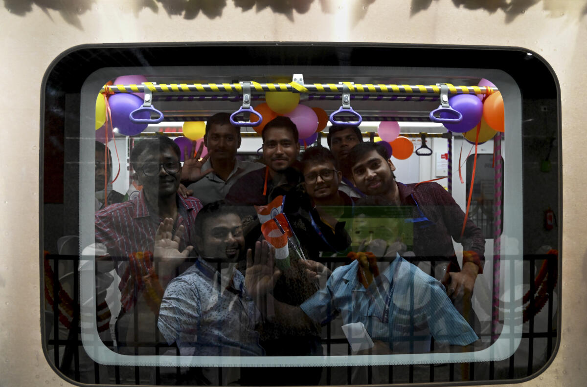 Passengers onboard a metro train of the newly inaugurated Yellow Line's Noapara to Jai Hind Bimanbandar stretch of Kolkata Metro, at Jessore Road metro station in Kolkata, Friday, Aug. 22, 2025. Prime Minister Narendra Modi on Friday inaugurated three new metro routes in the city.
