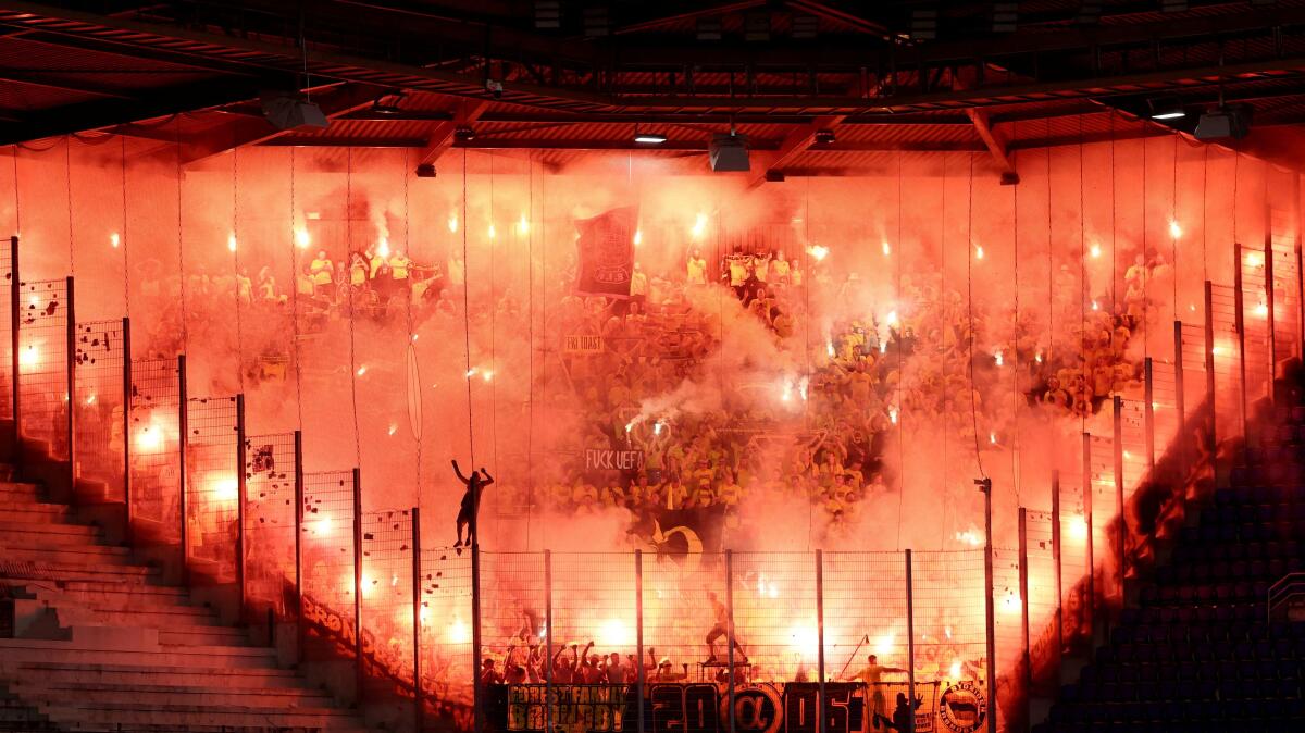 UEFA Conference League - Play Off - First Leg - RC Strasbourg v Brondby IF - Stade de la Meinau, Strasbourg, France - August 21, 2025 Brondby IF fans with flares inside the stadium before the match.