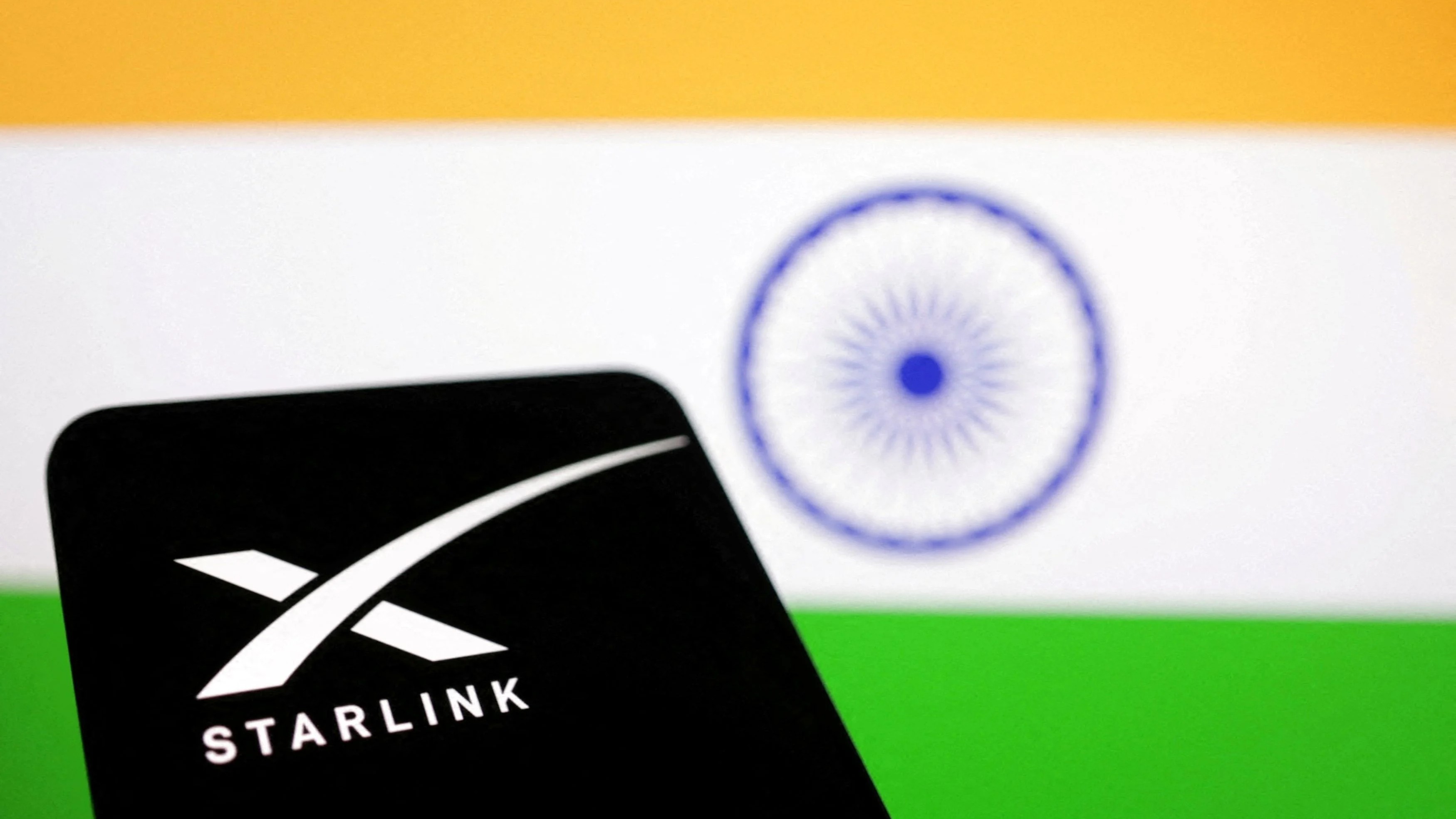 FILE PHOTO: The Starlink logo is seen in front of the Indian flag.