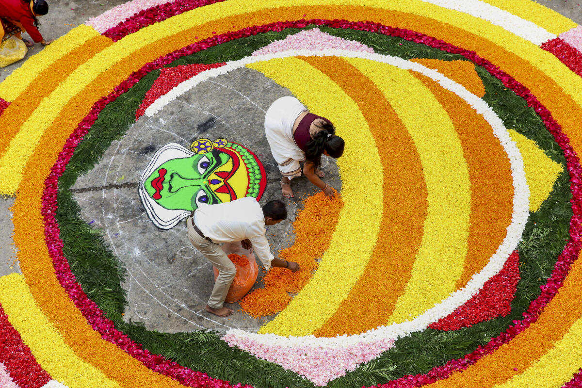People from the Malayali community prepare a 'Pookalam' ahead of the Onam festival celebrations, in Bhopal, Sunday, Aug. 24, 2025.
