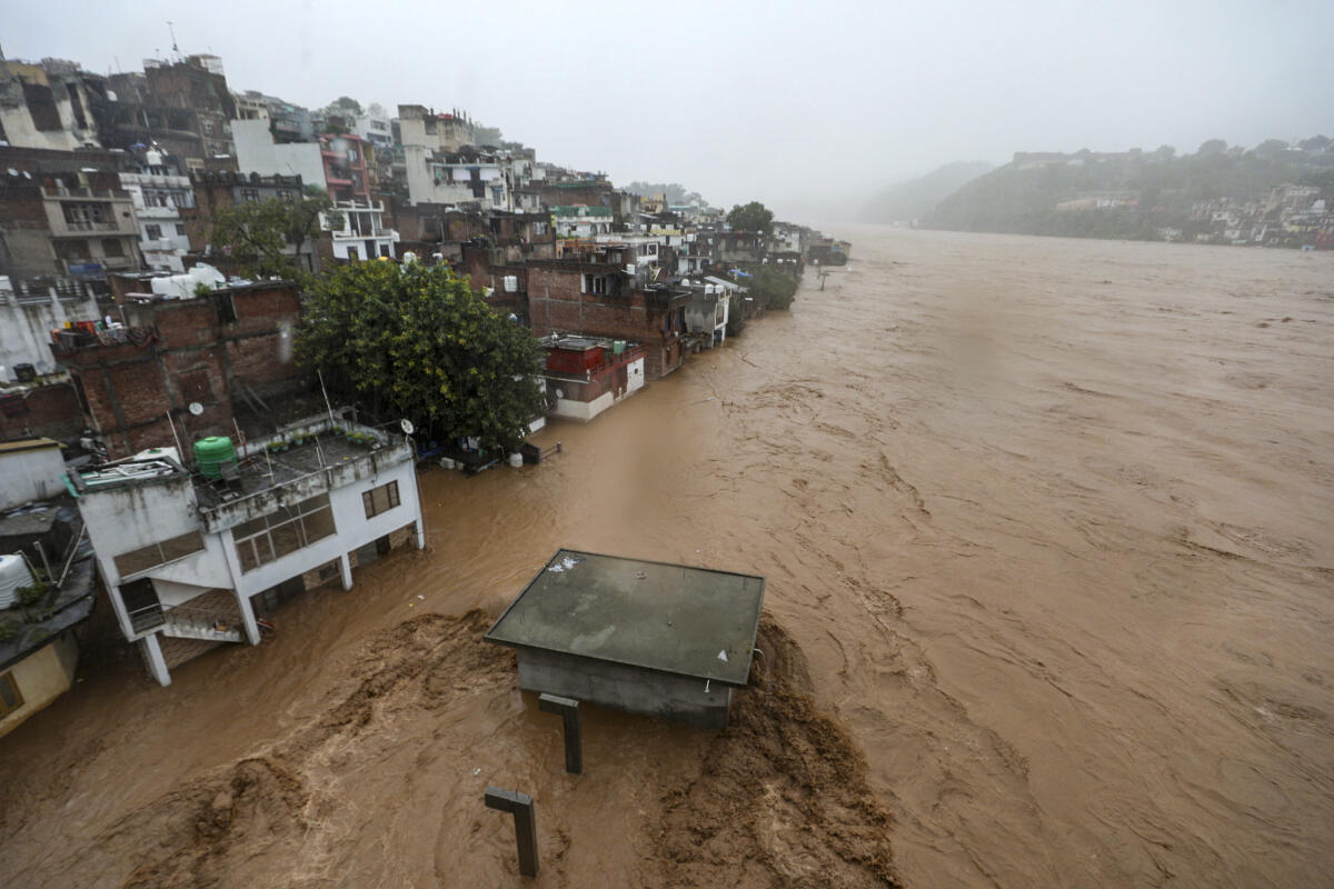 Structures partially submerged following heavy rainfall, in Udhampur, Tuesday, Aug. 26, 2025.