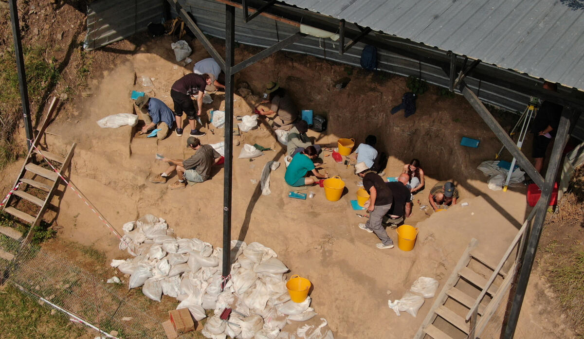 A drone view shows archaeologists working at the excavation site.