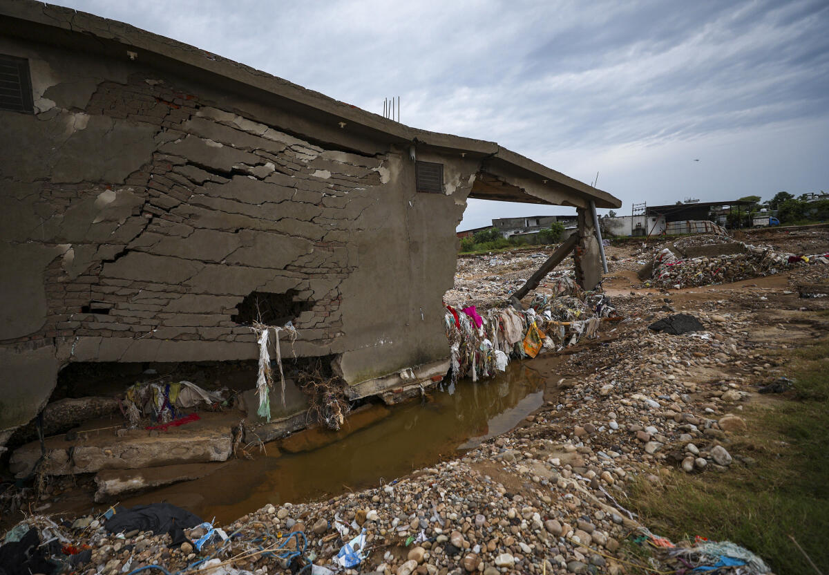 Remains of a damaged house at a flood ravaged area after heavy rainfall, at Chatha, in Jammu district