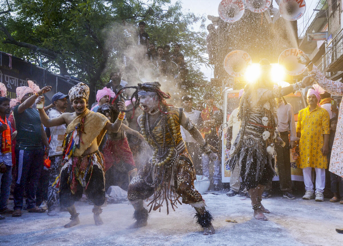 Artistes and people perform during a procession amid the ‘Ganesh Chaturthi’ festivities, in Ranchi, Jharkhand