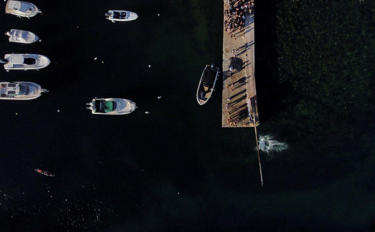A drone view shows water splashing as a competitor falls off the "gostra", a wooden pole covered in lard, during the celebrations for the religious feast of St Julian, patron of the town of St Julian's, Malta