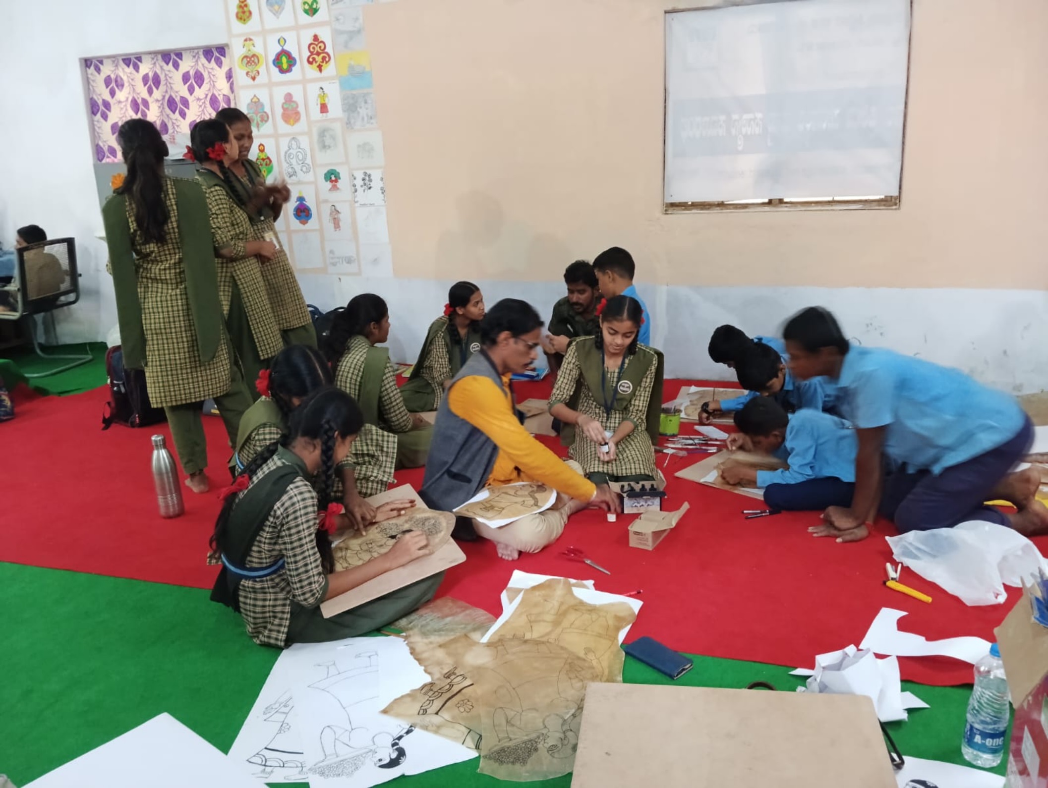 Teacher Mallikarjun Koralli teaching Togalu Gombe at Karnataka Public School in Kalaburagi.