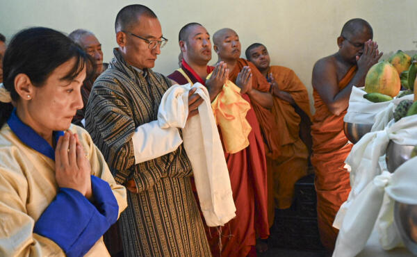 Bhutan Prime Minister Tshering Tobgay with his wife Aum Tashi Doma offers prayers at the Mahabodhi Temple, in Bodh Gaya, Bihar.