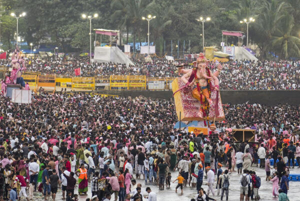 People take part in ‘visarjan’, immersion, of idols of Lord Ganesha during the 'Ganesh Chaturthi' festival, at Girgaon Chowpatty, in Mumbai, Maharashtra.