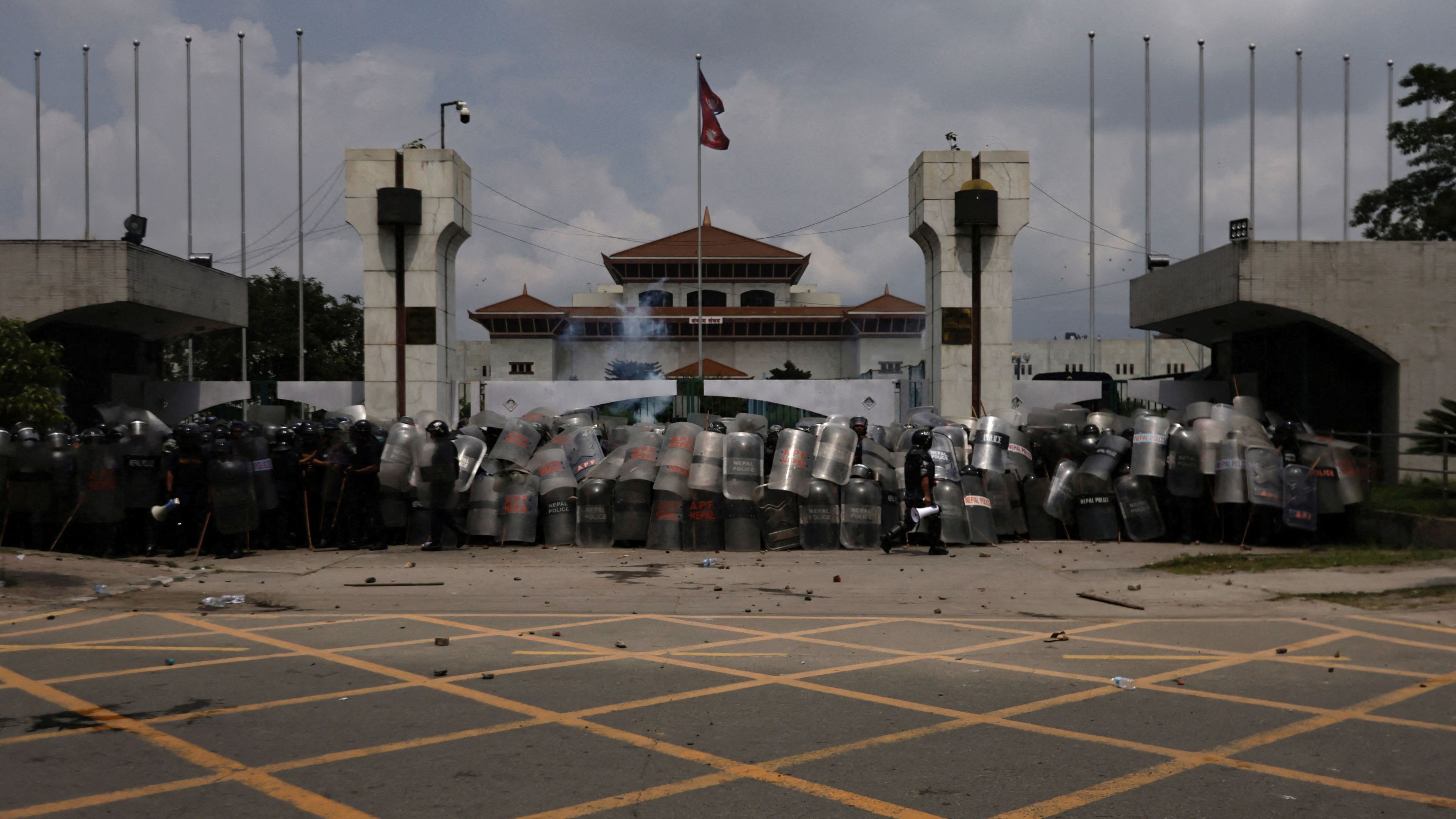 Police officers in riot gear guard the entrance of the Parliament during a protest against corruption and the government’s decision to block several social media platforms in Kathmandu.