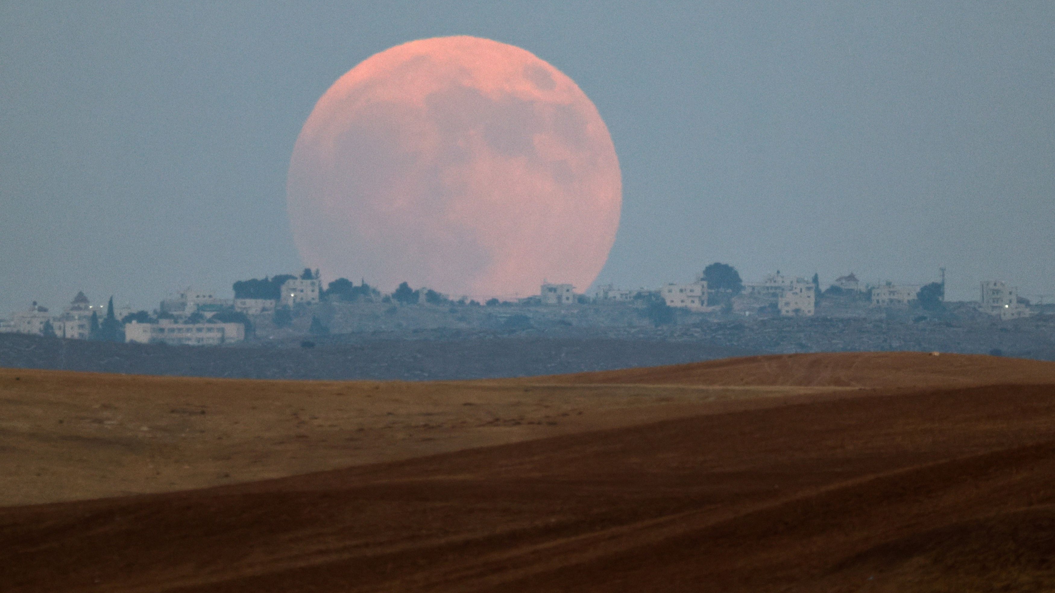 The 'Blood Moon' rises over the West Bank, as seen from the Negev desert, Israel.