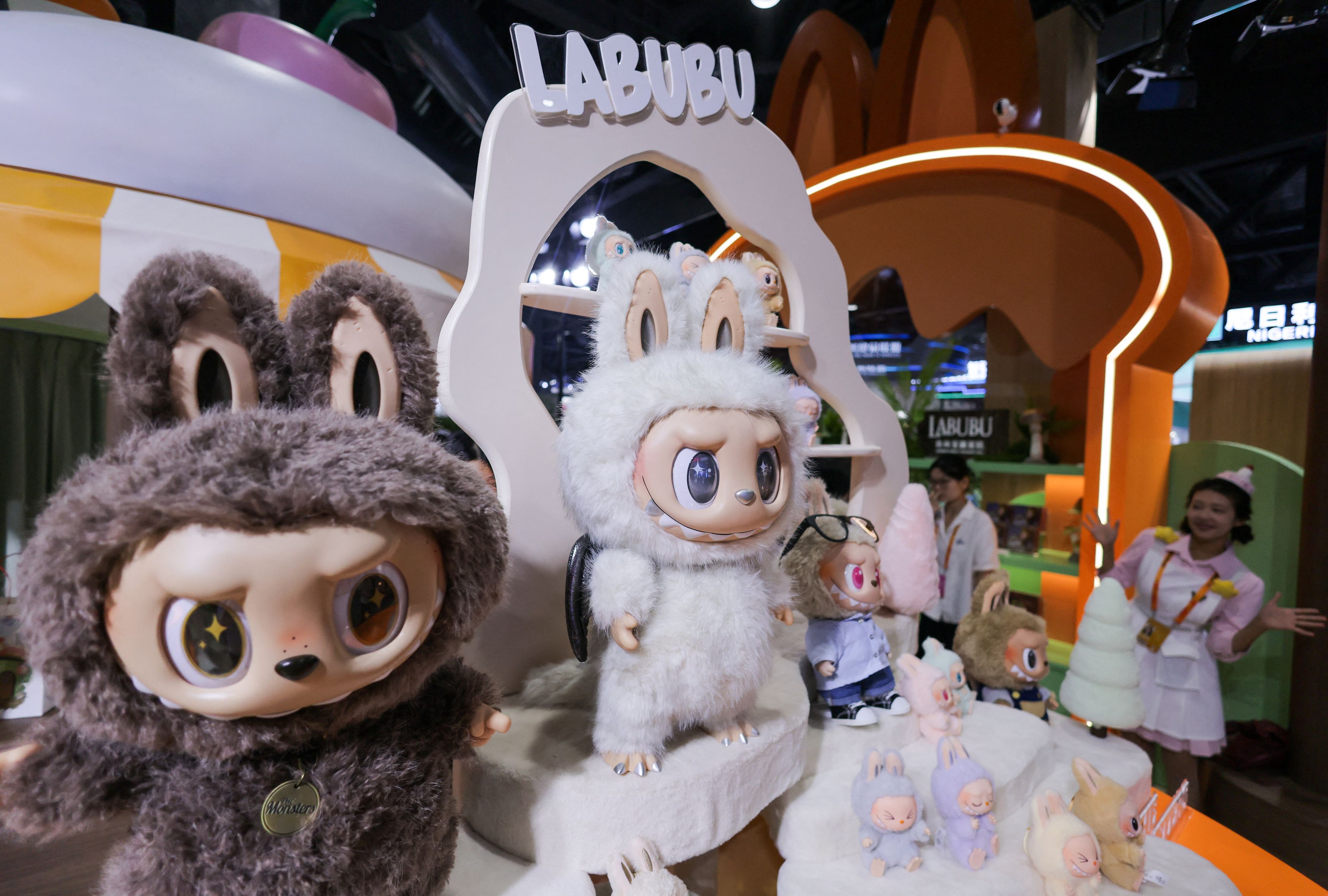 File Photo: An employee gestures next to Labubu toys on display at Pop Mart’s booth at China International Fair for Trade in Services (CIFTIS) in Beijing, China.