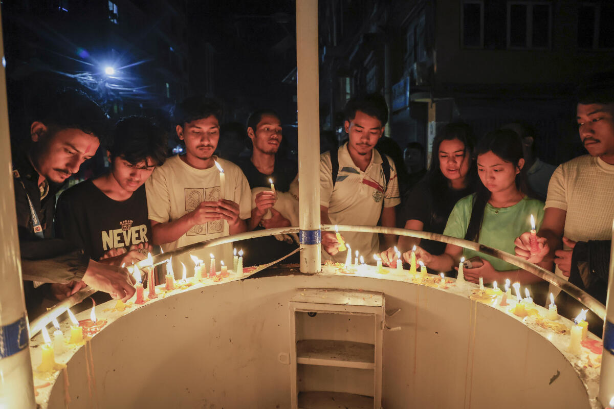 People take part in a candlelight vigil to pay respects to victims of the violence during the anti-government protests, in Kathmandu, Nepal.