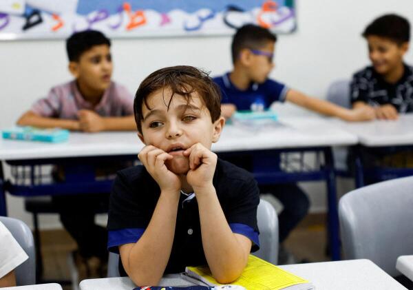A young displaced Palestinian boy from Gaza, who lost his eye due to war, takes part in a classroom activity at an education center in the Emirates Humanitarian City, on the first week of school, in Abu Dhabi, United Arab Emirates.