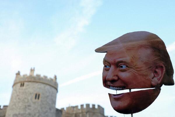 A cardboard cutout depicting U.S. President Donald Trump's face is held up during a "Trump Not Welcome" protest ahead of U.S. President Donald Trump and first lady Melania Trump's arrival for their state visit to Britain.