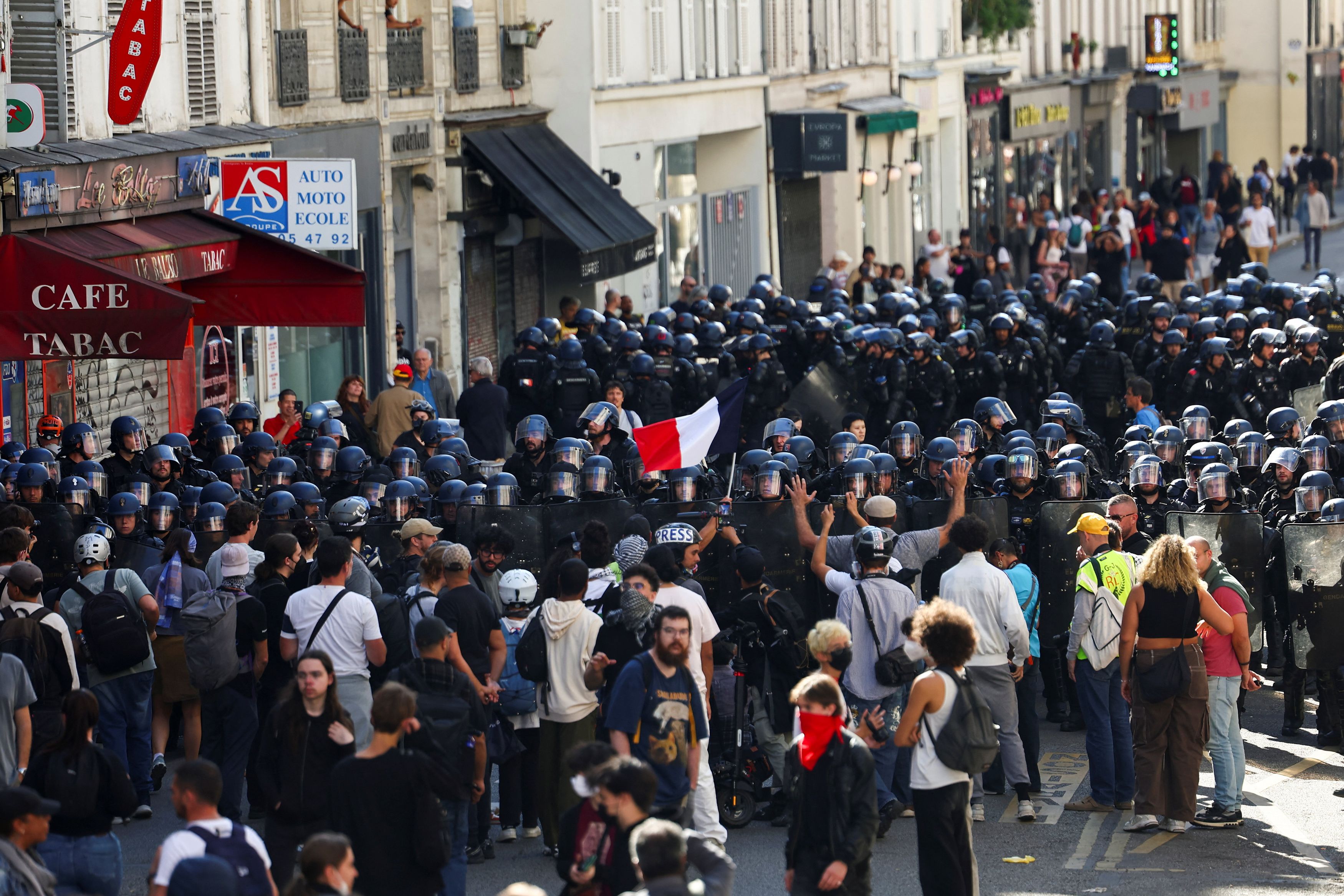 French riot police block protestors during clashes at a demonstration in Paris as part of a day of nationwide strikes and protests against the government and cuts in the next budget, with supporters of the "Bloquons Tout" (Let's Block Everything) movement, in Paris, France, September 18, 2025. REUTERS/Abdul Saboor