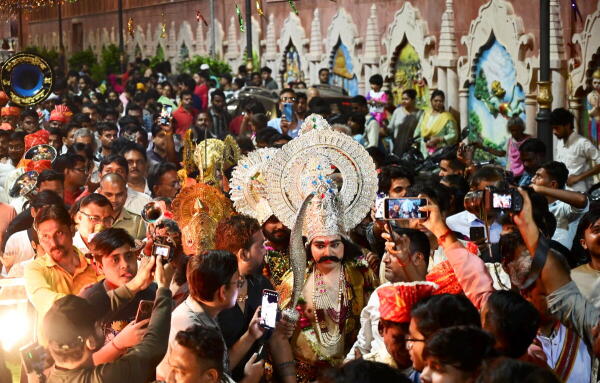 People take part in the traditional 'Ravan ki Barat' procession ahead of the Dusshera festival celebration, in Prayagraj.