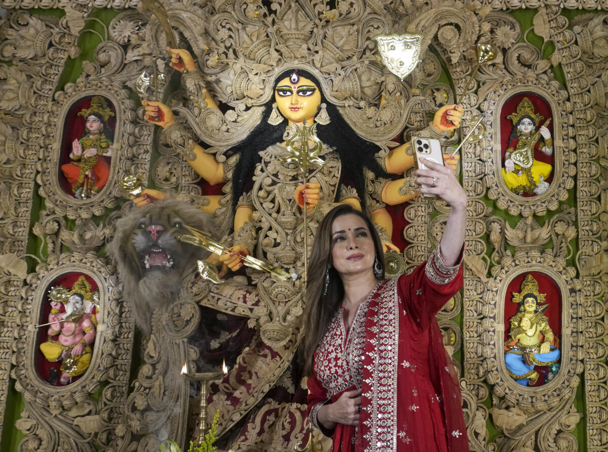 Actor Neelam Kothari clicks a selfie at a Durga Puja pandal, in Kolkata.