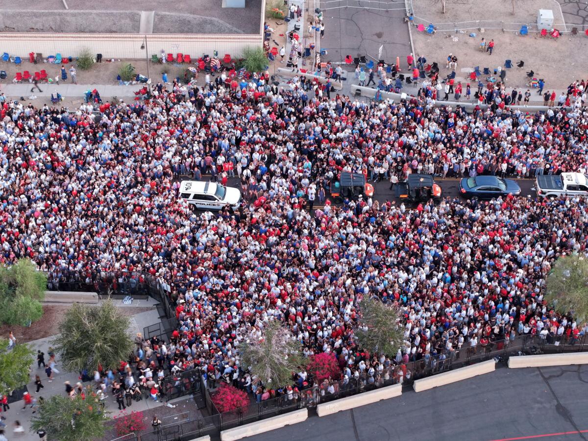 Drone view shows people as they arrive, wearing "red, white and blue" clothing, as suggested by Turning Point USA, to attend a memorial service for slain conservative commentator Charlie Kirk at State Farm Stadium, in Glendale, Arizona, US.