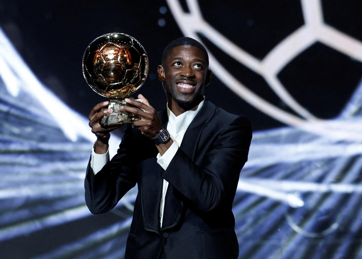 Paris St Germain's Ousmane Dembele celebrates after winning the men's Ballon d'Or award.