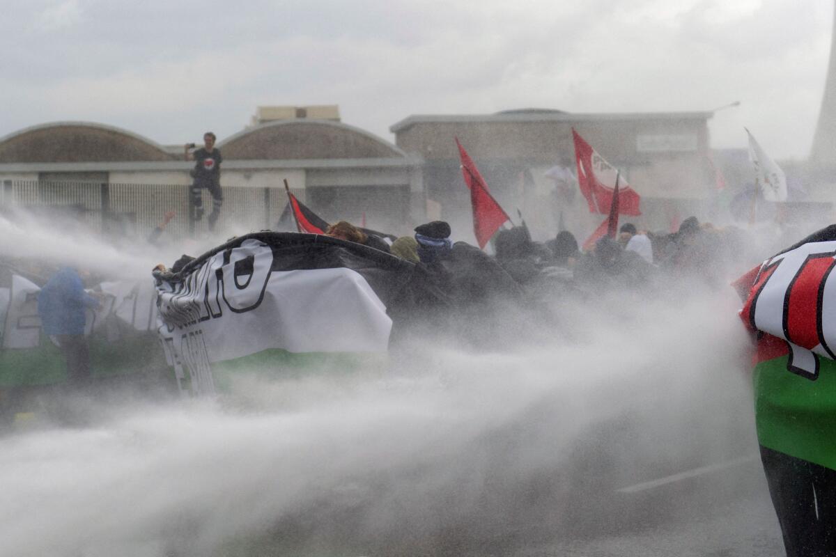 Police spray water on protesters at a demonstration that is part of a nationwide "Let's Block Everything" protest in solidarity with Gaza, with activists also calling for a halt to arms shipments to Israel, in Venice, Italy.