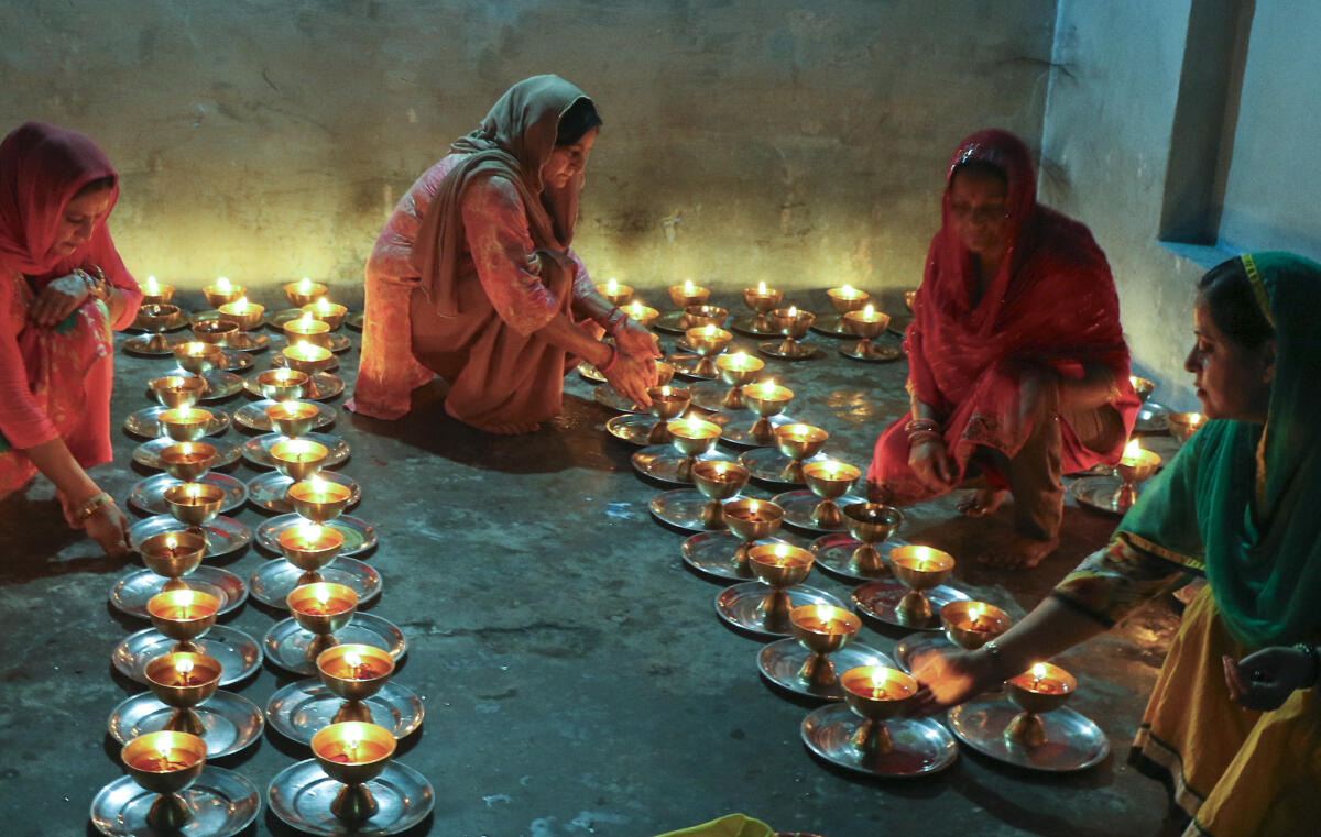 People light 'diyas' on the first day of the 'Navratri' festival, at Baba Sidh Goria Temple, in Jammu.