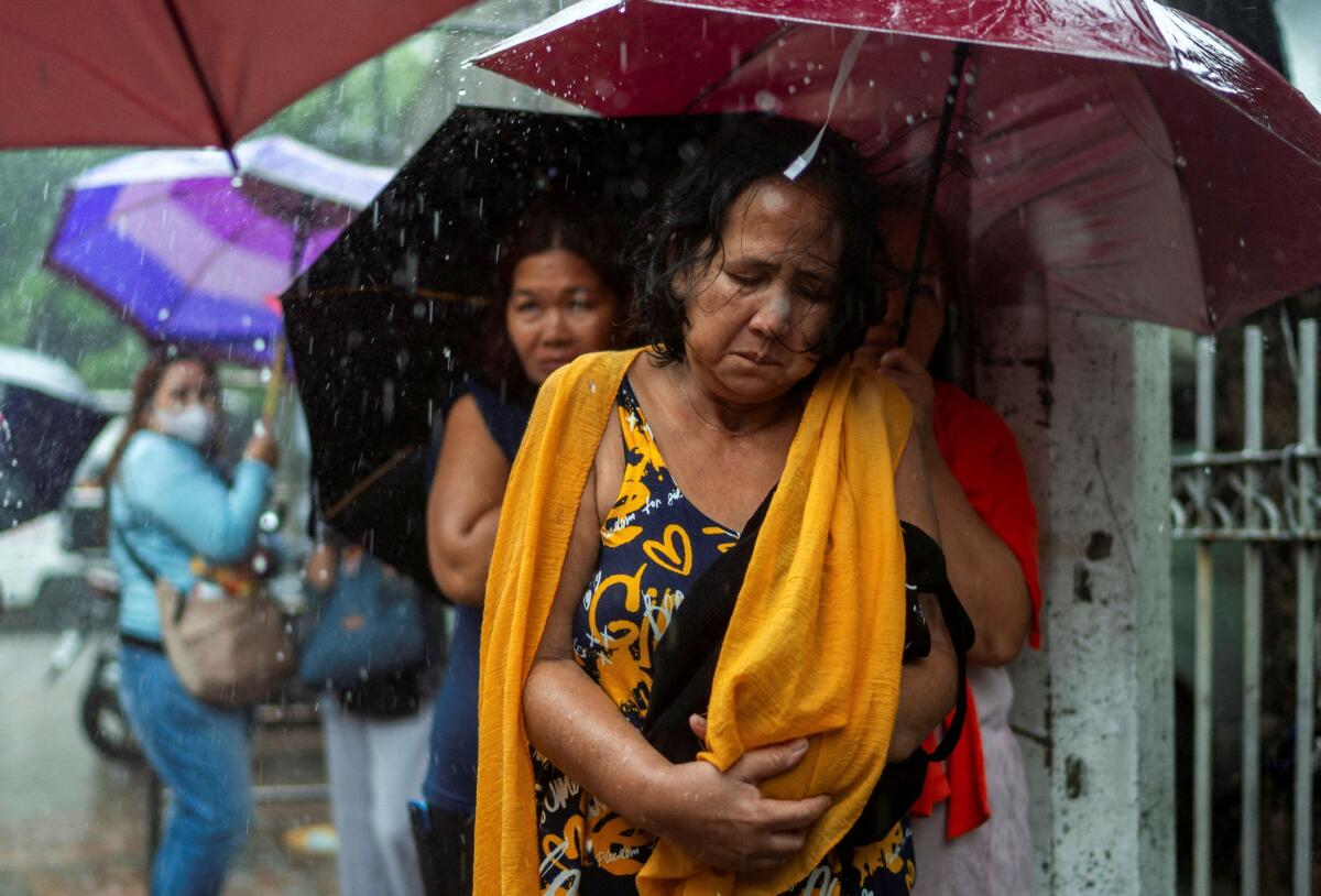 Relatives of detained individuals from the protest yesterday, where they denounced what they call corruption linked to flood-control projects, wait outside the Manila Police Station Headquarters, during a protest, in Manila, Philippines.