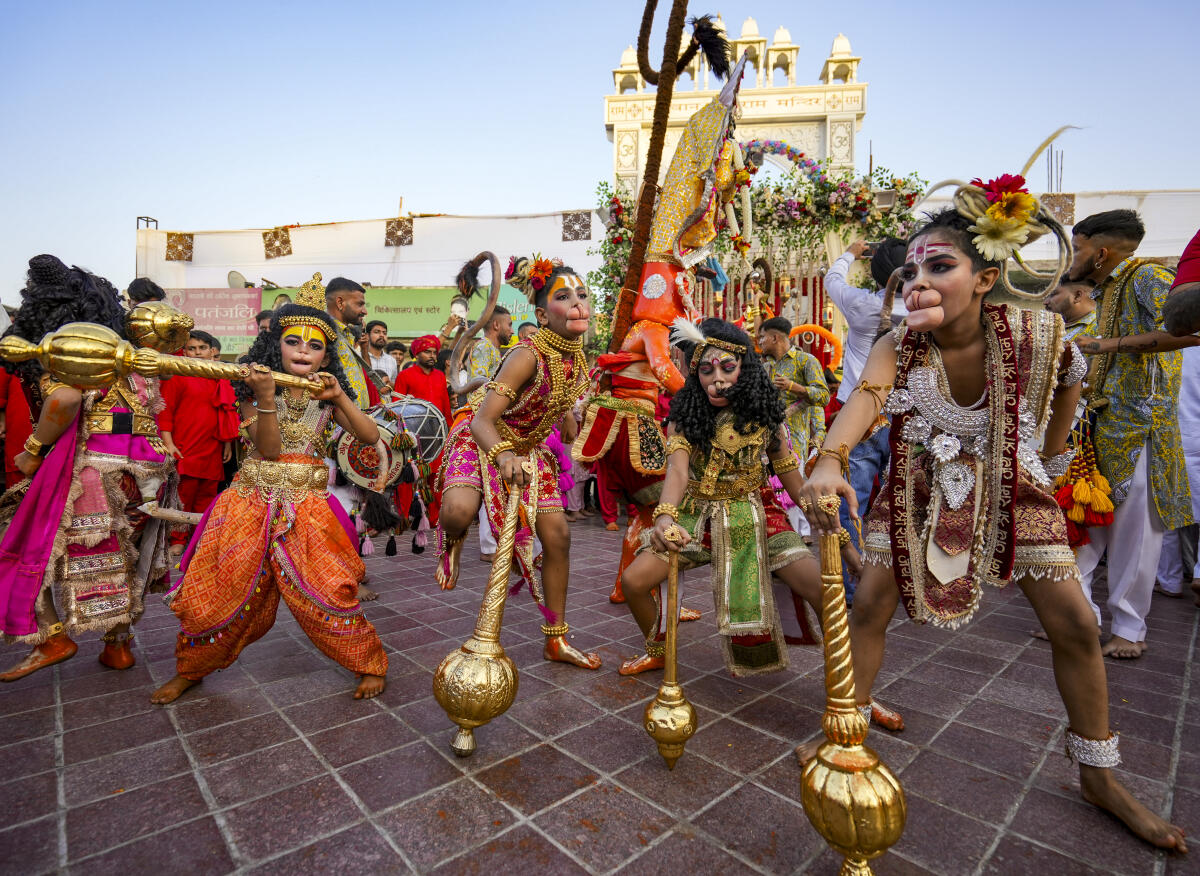 People dressed as Hindu deity Lord Hanuman take part in a religious procession during the Navratri festival and 'Langur Mela' celebrations at Durgiana Temple, in Amritsar, Punjab.