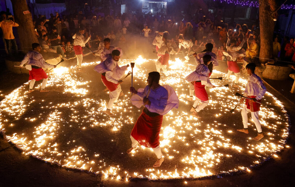 People take part in the 'Mashaal Raas', organized by the years old Patel Yuvak Garbi Mandal, in Jamnagar.