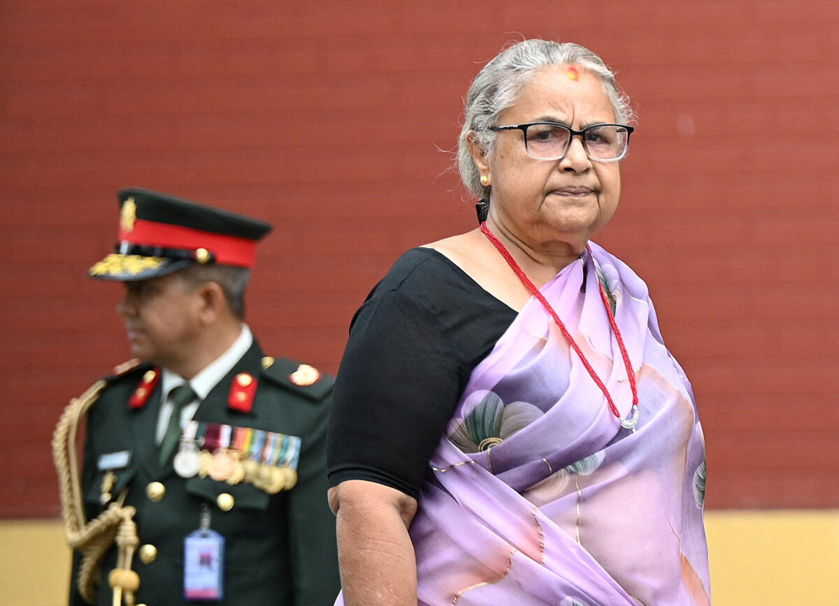 Nepal’s interim Prime Minister Sushila Karki arrives to attend the oath taking ceremony of her newly appointed four ministers Anil Kumar Sinha, Mahabir Pun, Madan Prasad Pariyar and Jagdish Kharel following recent anti-corruption protests that toppled the government, at "Shital Niwas", the presidential building that was ransacked and burned by the protesters, in Kathmandu, Nepal.