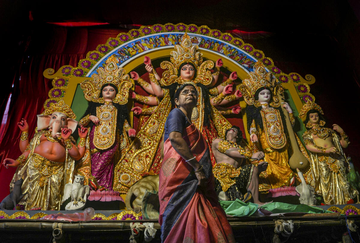 A woman at a pandal ahead of the 'Durga Puja' festival, in Kolkata, West Bengal.