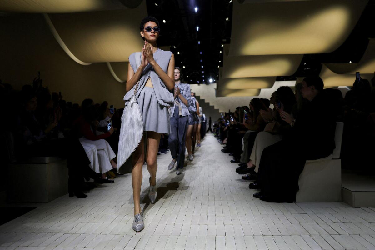 Models applaud at the end of the Emporio Armani Spring/Summer 2026 collection show during Milan Fashion Week, in Milan, Italy, September 25, 2025.