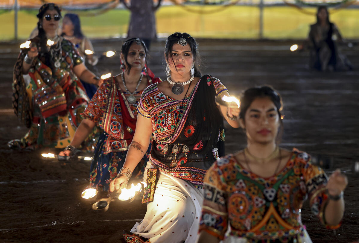 Women perform 'Garba' during the 'Abhivyakti Garba Mahotsav' organised as part of 'Navratri' festival celebrations, in Jaipur, Wednesday night.