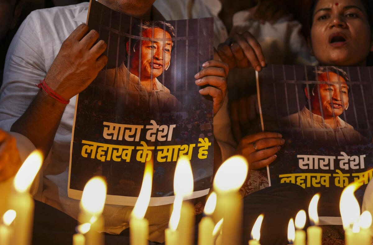Agitators hold posters during a protest by AAP over the arrest of climate activist Sonam Wangchuk, at Jantar Mantar, in New Delhi, Friday, Sept. 26, 2025.