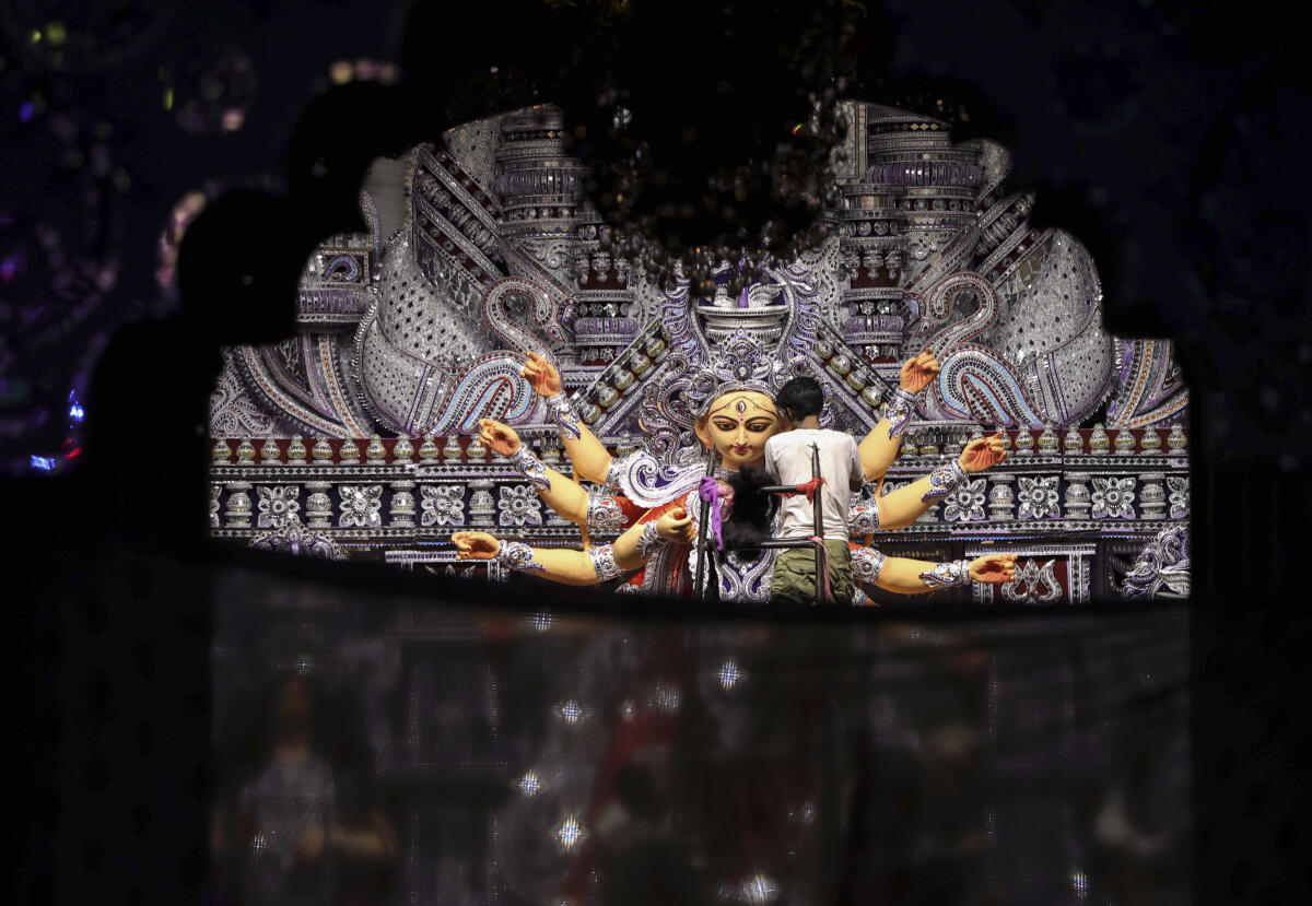 Prayagraj: An artisan works on an idol of Goddess Durga for the Durga Puja festival, in Prayagraj, Friday. 