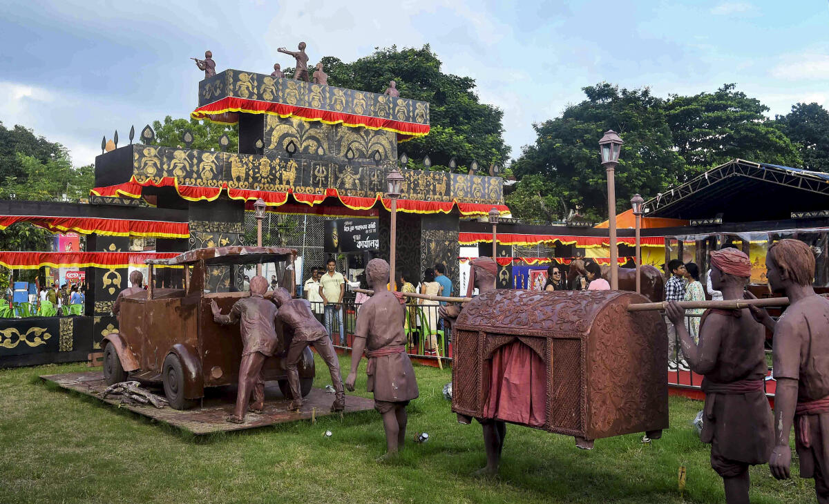 People visit a community pandal themed on 'Old Calcutta' amid the Durga Puja festivities, in Kolkata, Saturday, Sept. 27, 2025.
