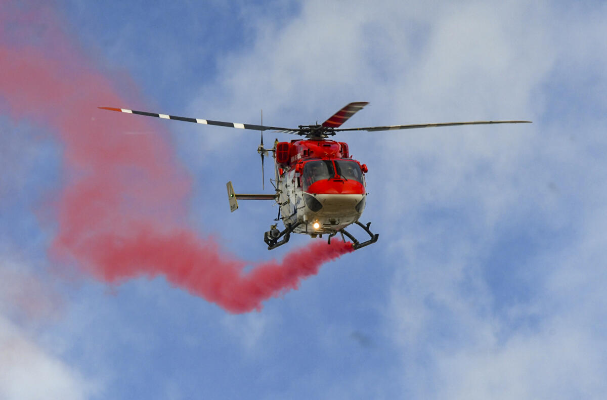 A helicopter of Indian Air Force’s (IAF) 'Sarang' team performs aerial maneuvers during Dasara Air Show, in Mysuru, Karnataka, Saturday, Sept. 27, 2025.