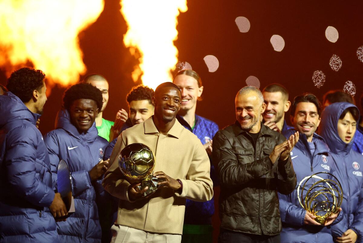 Paris St Germain's Ousmane Dembele celebrates with the Ballon d'Or after the match